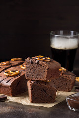 Chocolate brownie on dark beer with salted pretzels and chocolate. Delicious brutal dessert for men, sweet food