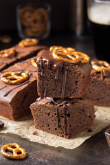 Chocolate brownie on dark beer with salted pretzels and chocolate. Delicious brutal dessert for...