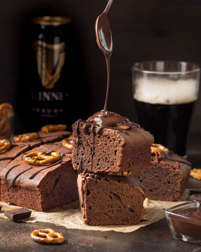 Chocolate brownie on dark beer with salted pretzels and chocolate. Delicious brutal dessert for men, sweet food