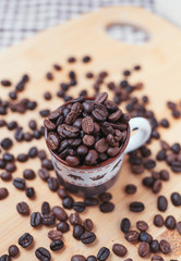 The dark roasted coffee bean in cup
