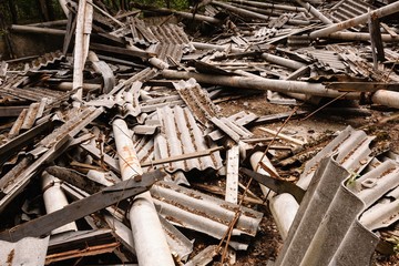Dilapidated building with reinforced concrete columns and broken slate.