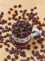 The dark roasted coffee bean in cup