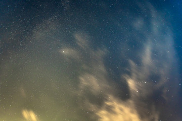night starry sky with long exposure clouds