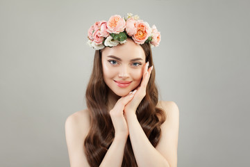 Young pretty woman with clear skin, healthy hair and flowers wreath