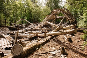 Dilapidated building with reinforced concrete columns and broken slate.