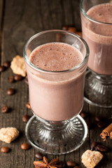 Chocolate, coffee, milk, banana shake on wooden background. Smoothie with cookies. Milkshake. Protein diet. Healthy food concept.
