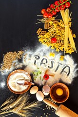 Home made traditional pasta. Flour grain egg pasta on black background. Home cooking food.