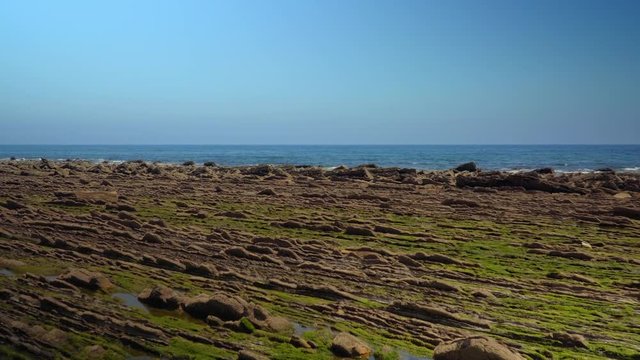 Crane down shot of rocks formations at coast