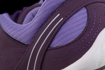 Fragment of a purple sneaker. The texture of the material of sports shoes