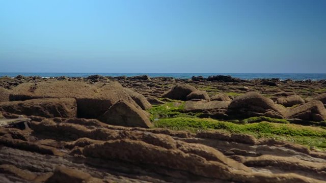 Soft crane up shot of geological formations at coast