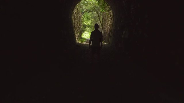 Still man in a tunnel starts running
