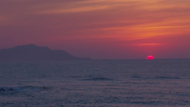 Sun of fire hiding in marine horizon