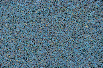 Blue rubber covering of a sports ground for children. Texture background. Outdoor sports flooring...