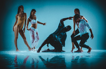 Group of dancer dancing on the stage with rain effect
