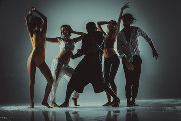 Group of dancer dancing on the stage with rain effect