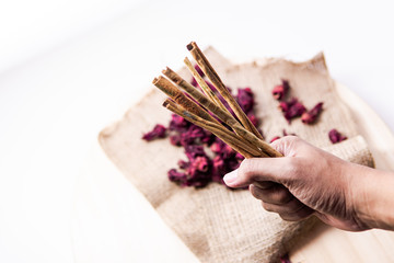 cinnamon and roselle flower tea are held in hand