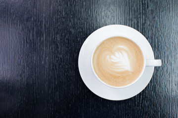 white Cup of cappuccino coffee with foam on the table in a cafe or restaurant