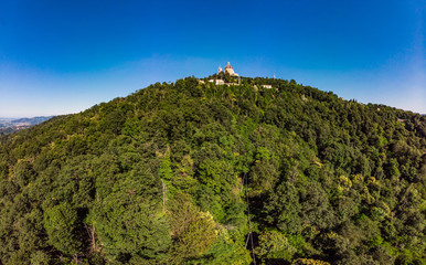 Beautifull aerial panoramic view to the famous from the drone Basilica of Superga in sunny summer day. The cathedral church located at the top of hill in italian Alps mountains. Turin, Piedmont, Italy
