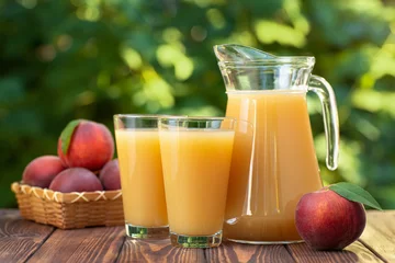Foto auf Acrylglas peach juice in glasses and jug © alter_photo