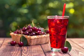 cherry juice or cocktail with ice in glass
