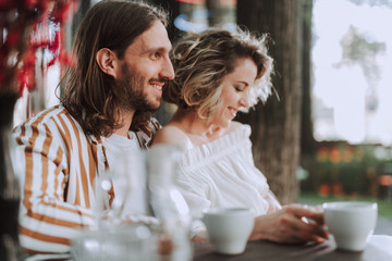 Beautiful couple spending time together in outdoor cafe