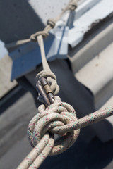 Naklejka premium Close-up system of ropes and carbines mounted on the roof for the industrial climber, selective focus
