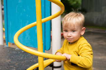 Fototapeta na wymiar Little boy playing on the playground.