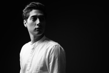 Young multi-ethnic handsome man in black and white