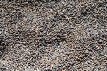 Sea pebble texture. Small rocks. Small multicolored pebble-stones. Beach stones surface.