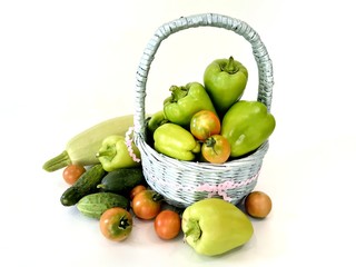 Vegetables in a basket, zucchini, peppers, cucumbers and tomatoes