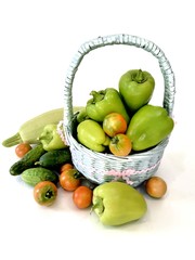 Vegetables in a basket, zucchini, peppers, cucumbers and tomatoes