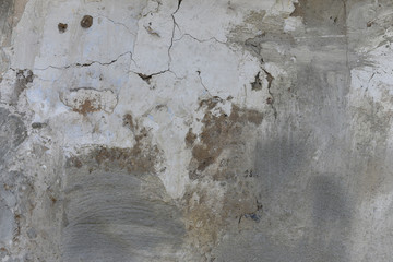 Old damaged wall background textere. Fragile plaster fragments, scratches, cracks, roughness. Design backdrop concept Copy space