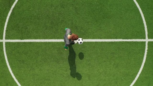 Top view from drone on football field football player stuffs ball. Soccer trains before match on football field on sunny day.