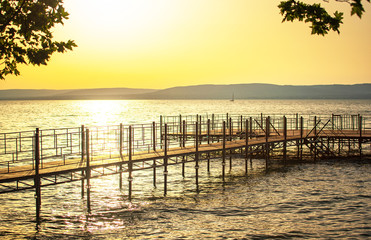 Pier with sunset at lake Balaton