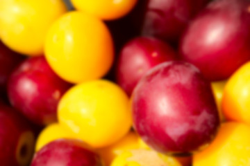 Fototapeta na wymiar Blurred cropped shot of plums. Food concept. Summer background. Colorful fresh plum. Ripe juicy plums.