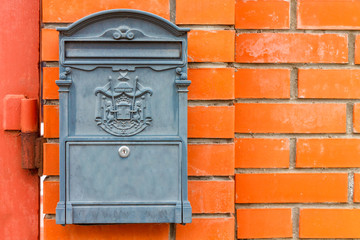 A beautiful mailbox hangs waiting for newspapers, parcels and letters.