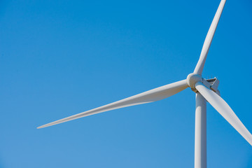 Wind Generator Turbine on the Blue Sky Bacground. Green Renewable Energy Concept.