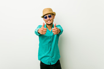 Young hispanic man wearing a summer clothes with thumbs ups, cheers about something, support and respect concept.