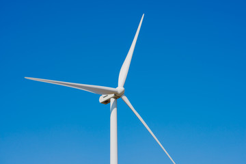 Wind Generator Turbine on the Blue Sky Bacground. Green Renewable Energy Concept.