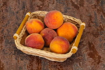 Peach heap in the wooden basket