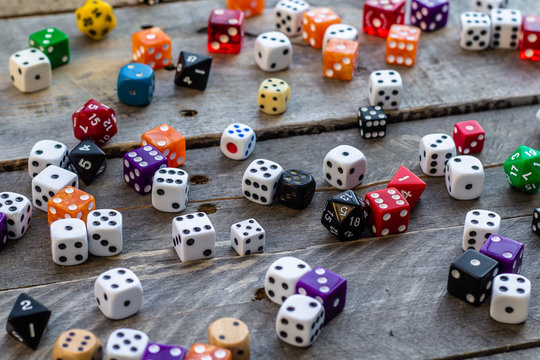 A bunch of dice on a wood background
