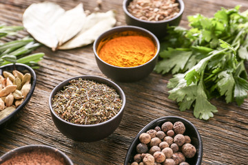 Different herbs and spices on wooden background