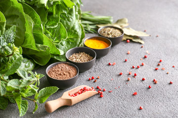 Different herbs and spices on grey background © Pixel-Shot