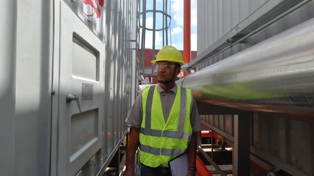 Asian Maintenance engineer at the waste water management system of a huge factory,maintenance checking technical data of heating system equipment,Thailand people	