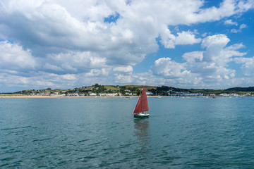 Yacht on the Torridge estuary with Instow in view in North Devon