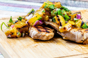 Marinated pork chops with grilled pineapple salsa. Calgary, Alberta, Canada