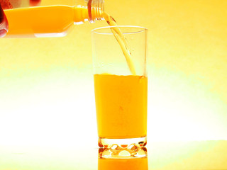 glass of juice with slice of orange