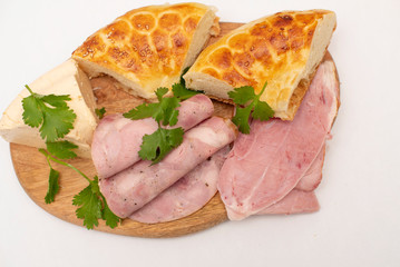 soft cheese, slices of meat and flatbread