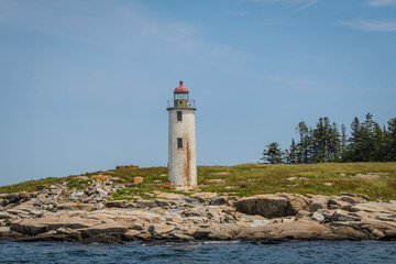 Fototapeta na wymiar Franklin Island Lighthouse on a sunny summer day on Franklin Island, Muscongus Bay, Maine
