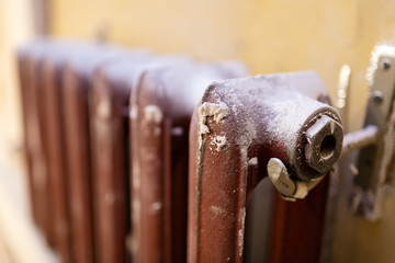 Heating cast-iron radiator  in apartment that is under construction, remodeling, renovation, overhaul, extension, restoration and reconstruction. Concept of home improvement.